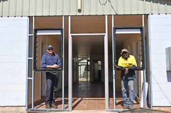 Department of Local Government, Housing and Community Development staff member Fred has a chat to local Kybrook Farm resident Patrick about his work on the latest Room to Breathe upgrades.