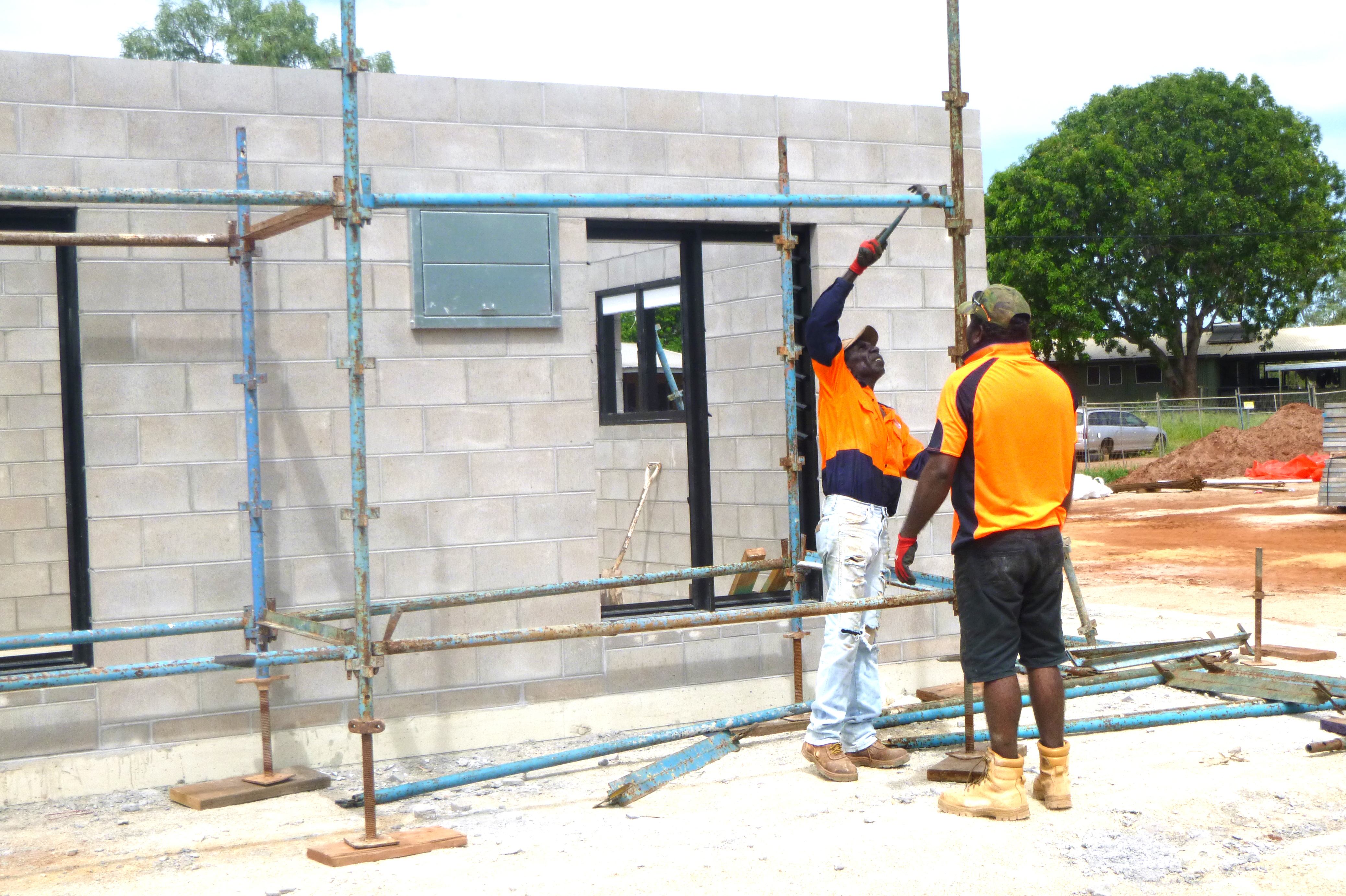 (From left to right) Michael Murrimal and Justin Maroney working on the scaffolding for one of the three bedroom homes planned for Binjari